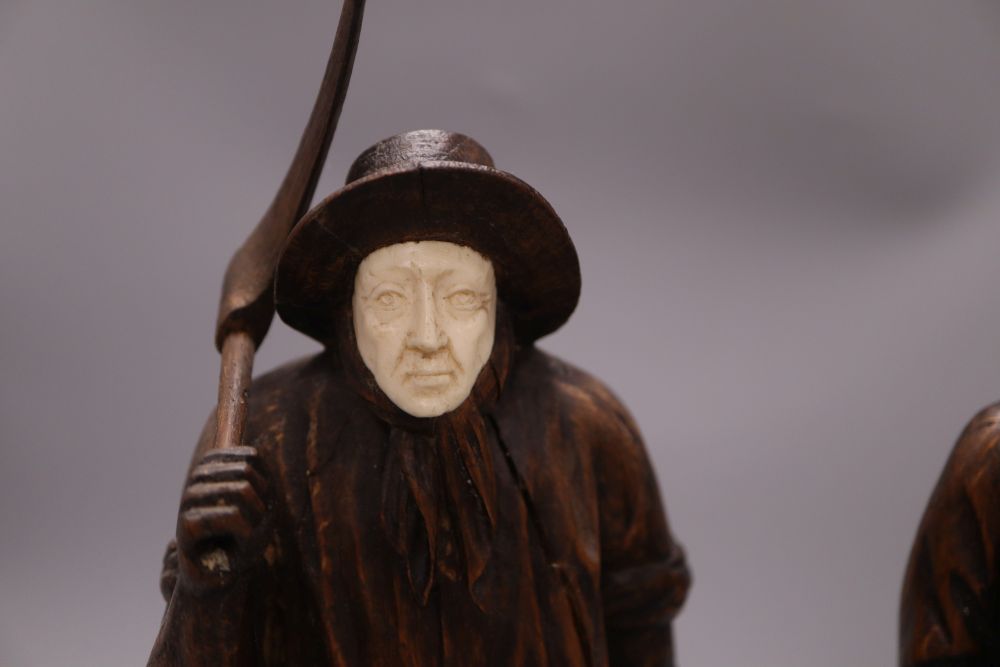Two carved wood figures of workmen, with ivory faces, signed Neri, height 31cm